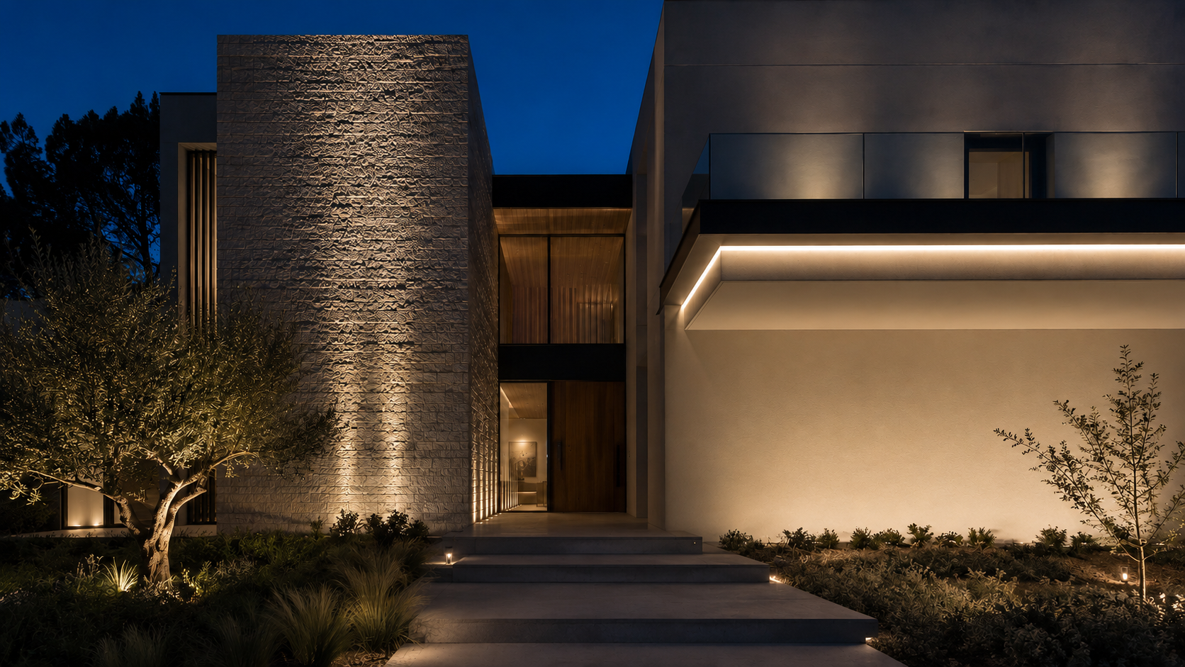 Contemporary facade at blue hour with stone grazing, smooth wall washing, concealed linear, path and landscape lighting layers