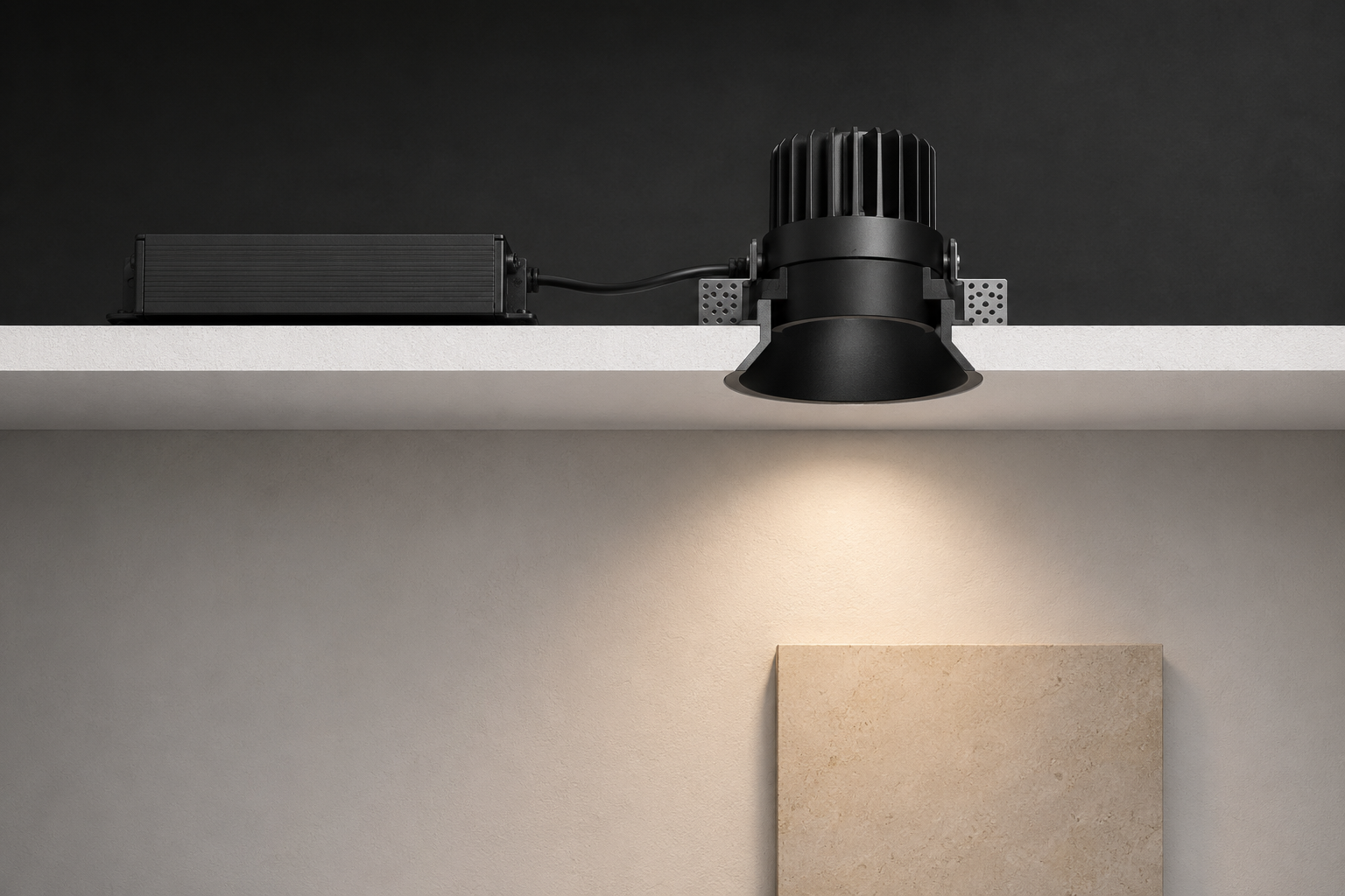 Sectional cutaway of a trimless deep-recessed downlight with remote driver and controlled beam